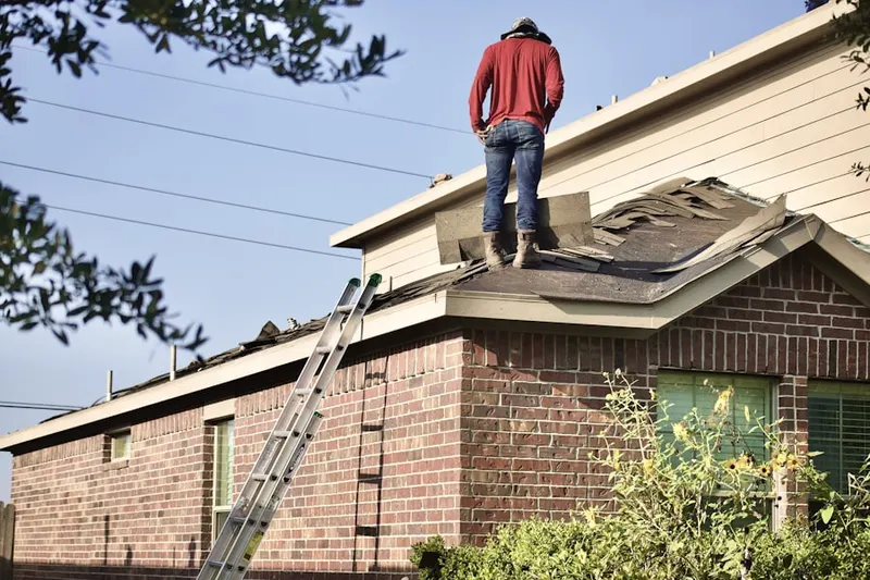 Professional roofer working on a residential roof in Setauket
